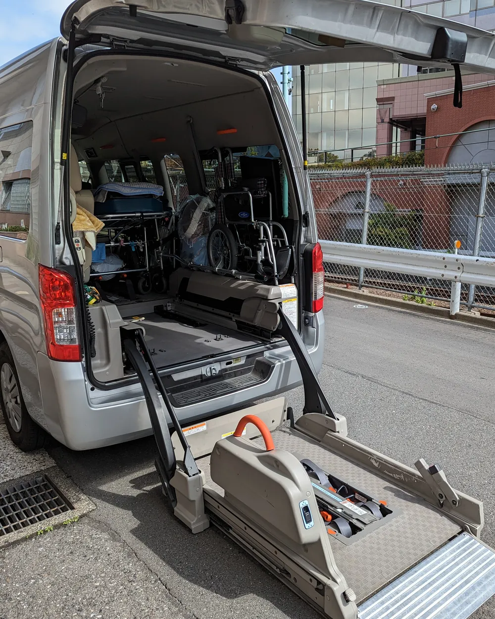 A wheelchair-accessible van with its rear lift lowered to the ground
